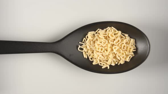 Black Spoon Is Filling By Figural Pasta (Letters And Numbers) alt