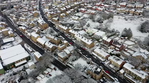 Aerial footage in the winter time on a snowy day of the British town of Mirfield in Kirklees alt