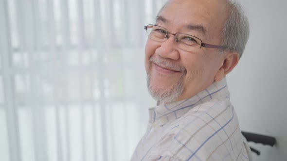 Portrait of happy Asian senior man looking and smiling to camera