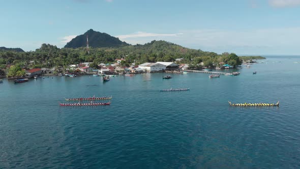 Aerial: kora-kora traditional canoe annual race in Banda Neira in Indonesia alt