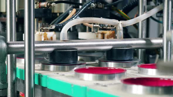 Foil Is Getting Put Onto Boxes Relocated By the Transporter. Packing Process at Factory alt