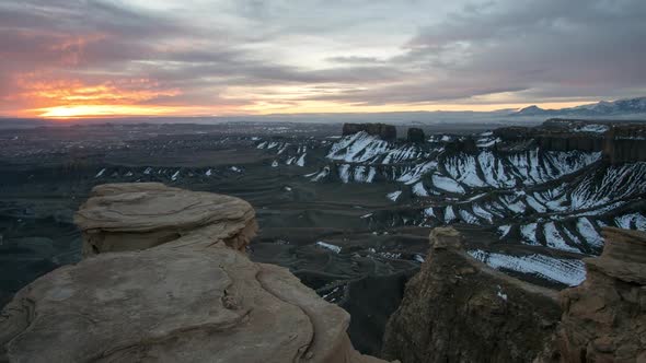 Time lapse of the sun peaking through the clouds lighting up the desert alt