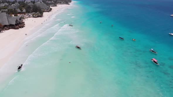 Aerial View of Fishing Boats Swaying on the Waves Off a Paradise Beach Zanzibar alt
