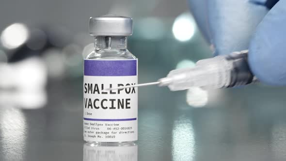 SmallPox vaccine vial in medical lab with syringe alt
