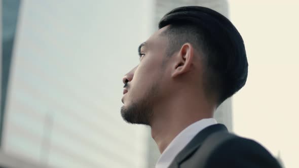 Attractive businessman in black suit thinking about future business projects.