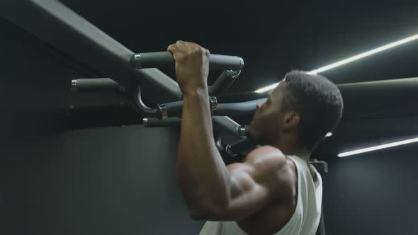 Handsome Afro American Muscular Man Doing Pull Ups on Horizontal Bar alt