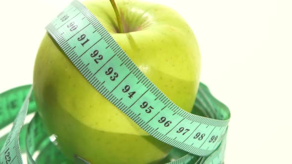 Green Apple with Measuring Tape on White, Rotation, Reflection alt
