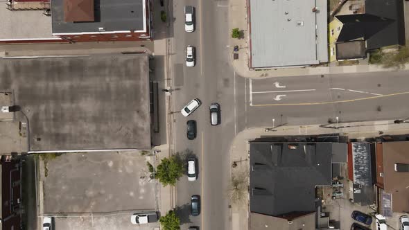 Aerial flyover downtown of Grimsby in Canada with traffic on road during rush hour time and sunlight alt