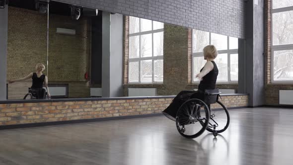 Disabled Dancer Whirling on Wheelchair in Ballroom alt
