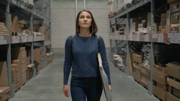 Young Female Carring Packing with Goods in Shop Warehouse alt