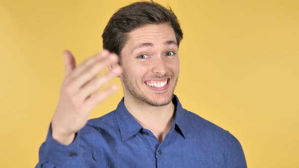 Inviting Man on Yellow Background alt