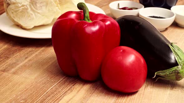 Fresh Ripe Aubergine Pepper Tomato on Wooden Table