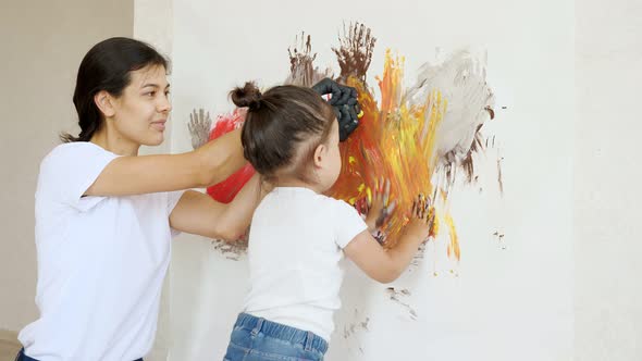 Mom Adds Paints on Canvas and Little Daughter Smudges alt