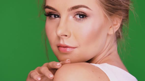 Young and Beautiful Woman Laughing and Touching Her Face alt