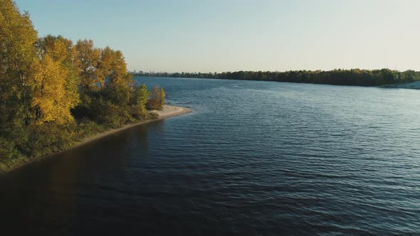 Aerial Drone Footage. Flight Near Island Over River Water at Autumn Season