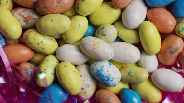 Rotating shot of colorful Easter candies on a bed of easter grass alt