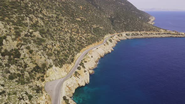 Aerial View of Curves Coastline Road Along Sea alt