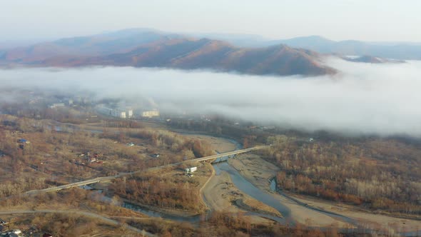 Flight Over the Valley Covered with Morning Mist in the Countryside alt