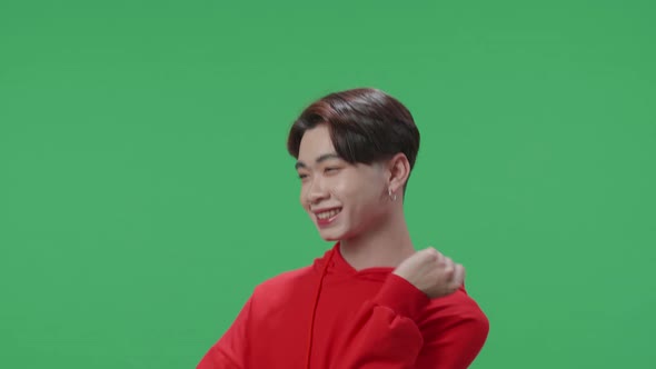 The Smiling Asian Transgender Male Dancing Sides While Standing On Green Screen In A Green Screen alt