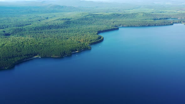 Landscape with Riverside Wooded Area Boats