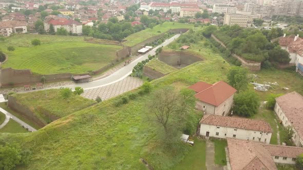Aerial circling Shot of side of Citadel Walls/ruins Trees visible in Alba-Carolina , Alba-Iulia, Rom alt