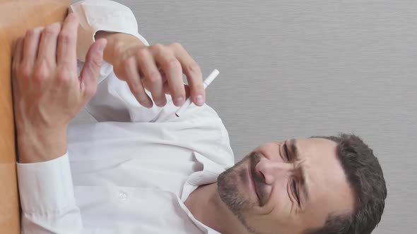 Vertical Video of Man Breaks Cigarette