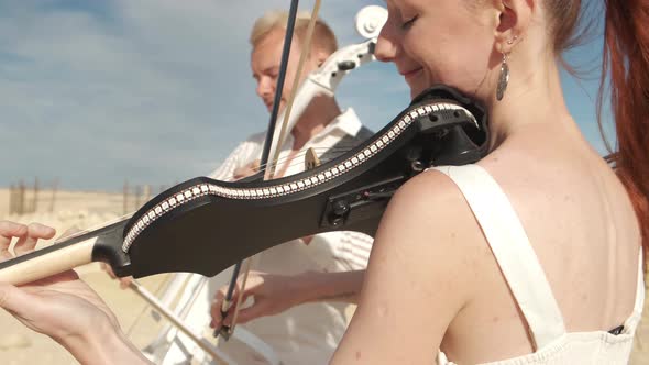 Musical duet playing a cello and a violin