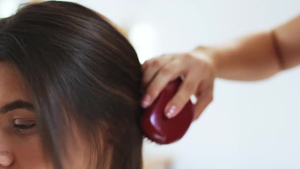 Hairdresser Combing Hair to Brunette Girl in Beauty Salon Slow Motion Close Up alt