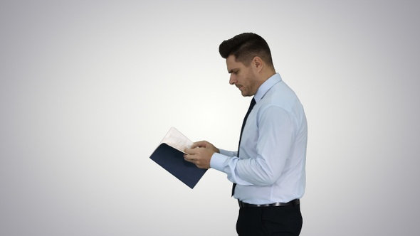 Young confused man trying to read smart book misunderstanding alt