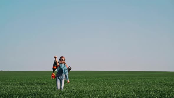 Kid with Jet Pack Outdoor Child Playing in Green Spring Field alt