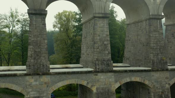 Rising Above the Arch Bridge or Aqueduct and Forest Around