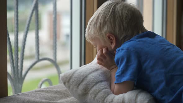 Stay at Home Quarantine Coronavirus Pandemic Prevention, Four Year Old Boy Looks Through the Window