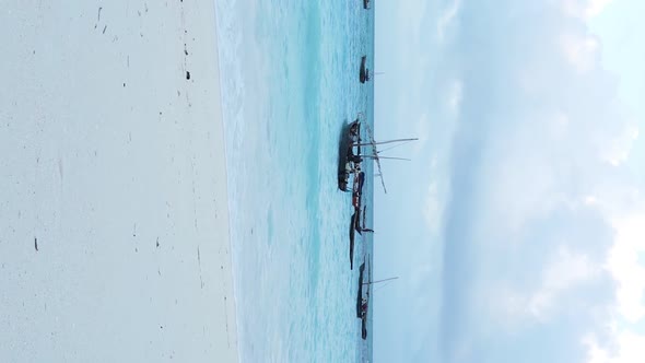 Vertical Video Boats in the Ocean Near the Coast of Zanzibar Tanzania Aerial View alt