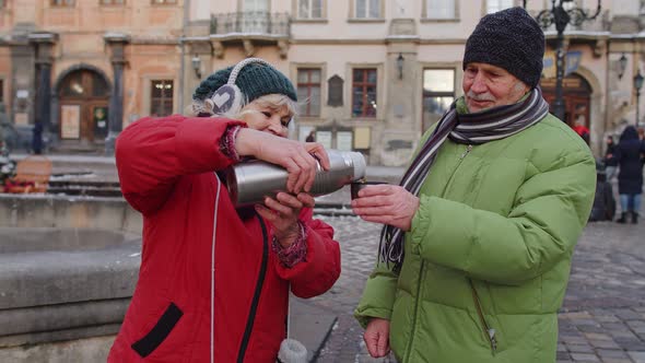 Senior Couple Tourists Grandmother Grandfather Drinking From Thermos Enjoying Hot Drink Tea Coffee alt