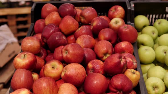 Closeup of a Lot of Red Apples in a Box on a Shelf in a Supermarket alt