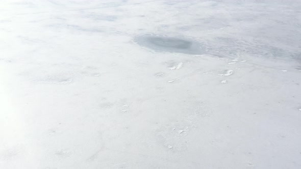 Winter scenery of frozen lake waters 4K aerial footage