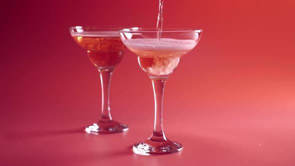 Closeup of Glass with Sparkling Rose Wine Decorated Gold Star Confetti Celebration Party alt