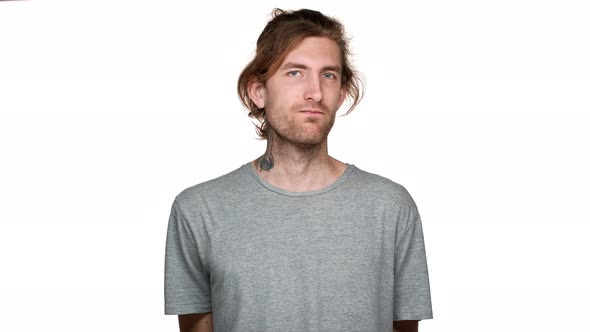 Portrait of Unshaved Tall Guy Shaking Head in Rejection and Answering No to Proposal Isolated Over alt