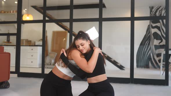 Two Girlfriends Hug Each Other After Yoga alt