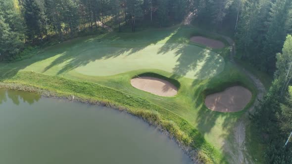 Green Fields in Summer Sunny Day Flying Over the Pond Aerial View of Golf Course in Forest Area Golf alt