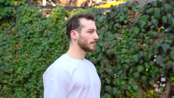 Young man walking in the park. alt
