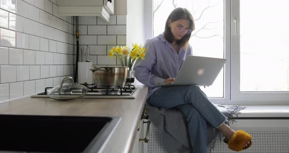 Businesswoman preparing breakfast in a minimalist white kitchen. alt