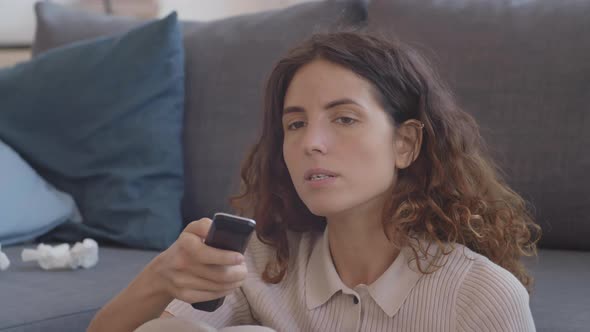 Sneezing Woman Switching TV Channels alt