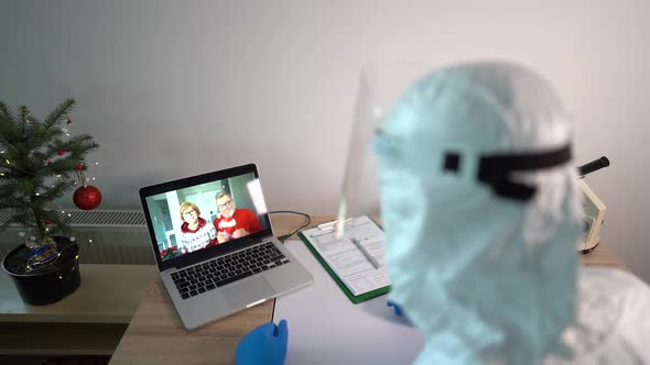 Male Doctor in the Laboratory Uses a Laptop Gadget for a Video Call with His Parents alt