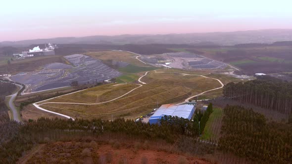 Aerial View Over Factory Building On Edge Of Landfill Site In Galicia, Spain. Dolly Left alt
