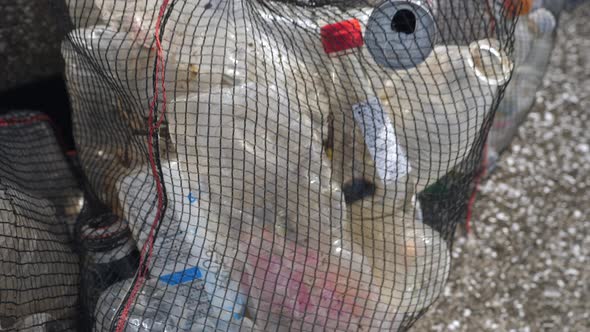The Black Net Bag Full of Plastic Bottles in Koijigahama Beach in Tahara Japan alt