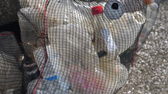 The Black Net Bag Full of Plastic Bottles in Koijigahama Beach in Tahara Japan