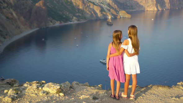 Children Outdoor on Edge of Cliff Seashore