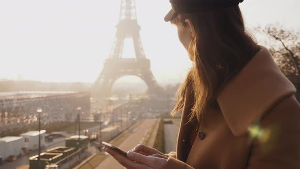 Beautiful Young Brunette Businesswoman Using Smartphone Shopping App at Epic Sunny Paris Eiffel alt