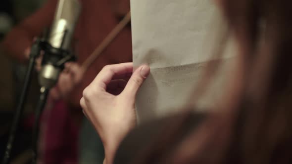 Rehearsing an Instrumental Melody with Violin By Female Musician with Headphones alt